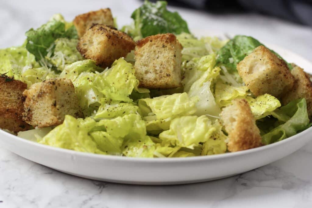 croutons with Caesar salad on plate