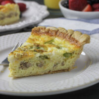 piece of quiche on plaste with fork