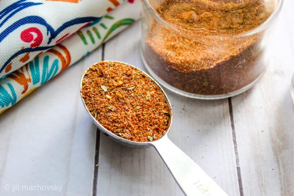 Easy Taco Seasoning Mix in jar and tablesppon on table with napkin