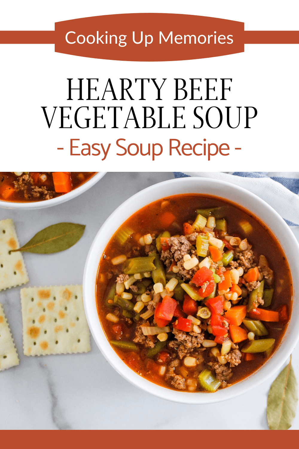 bowl of vegetable beef soup with basil leaves and crackers