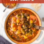 Hearty Hamburger Soup in a ladle.
