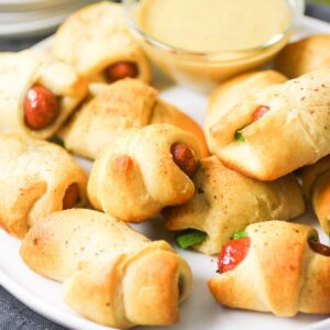Jalapeno Popper Pigs In a Blanket with a dipping sauce.