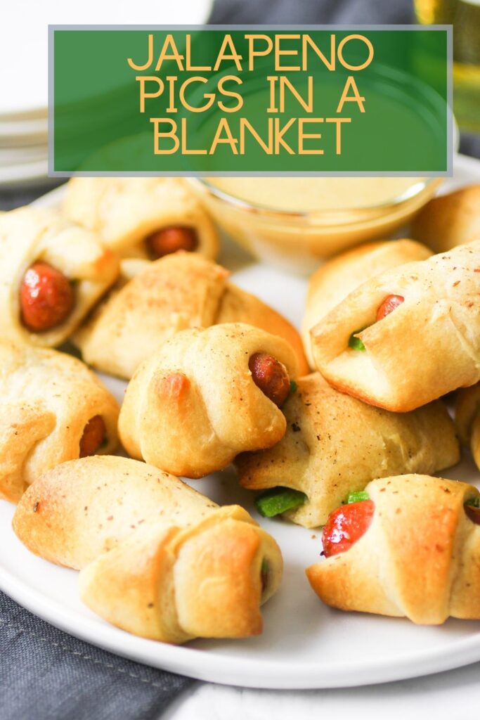 Jalapeno pigs in a blanket on plate with dipping suace and script