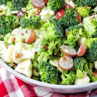 broccoli cauliflower salad with grapes, bacon in bowl