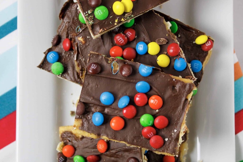 saltine toffee bars on plate with colorful napkin