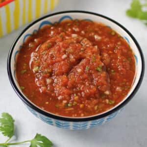 salsa in bowl with cilantro and chips