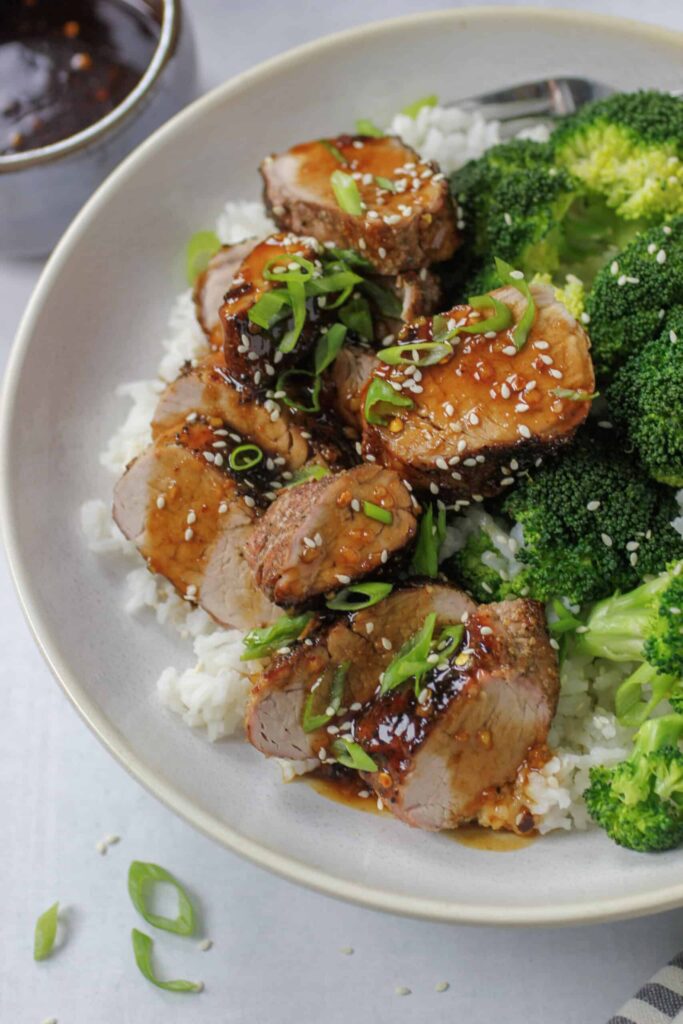 Grilled Asian pork tenderloin with rice and broccoli.