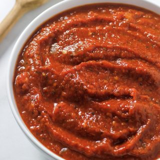 marinara sauce in bowl with wooden spoon