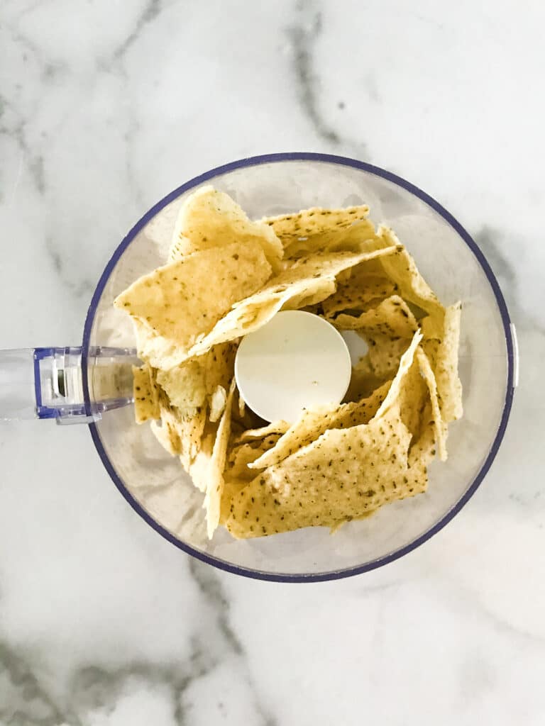 tortilla chips in small food processor.