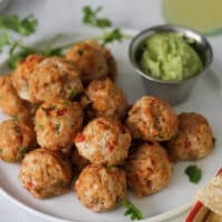 southest chicken meatballs on plate with avocado cream sauce for dipping