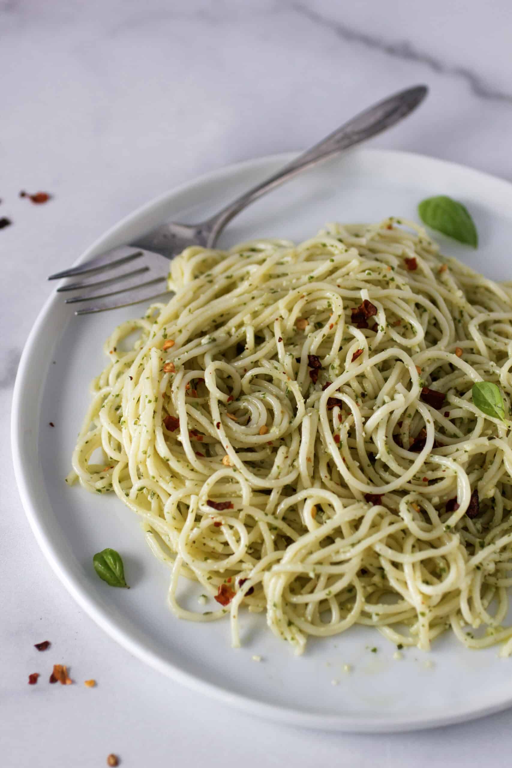 Creamy pasta on a plate with a fork.