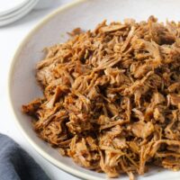 instant pot pulled pork with bowl with napkin and extra plates