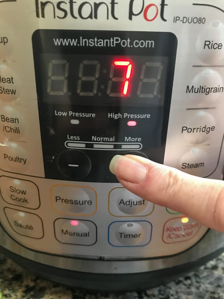 picture of instant pot with finger showing to cook on high pressure for 7 minutes.