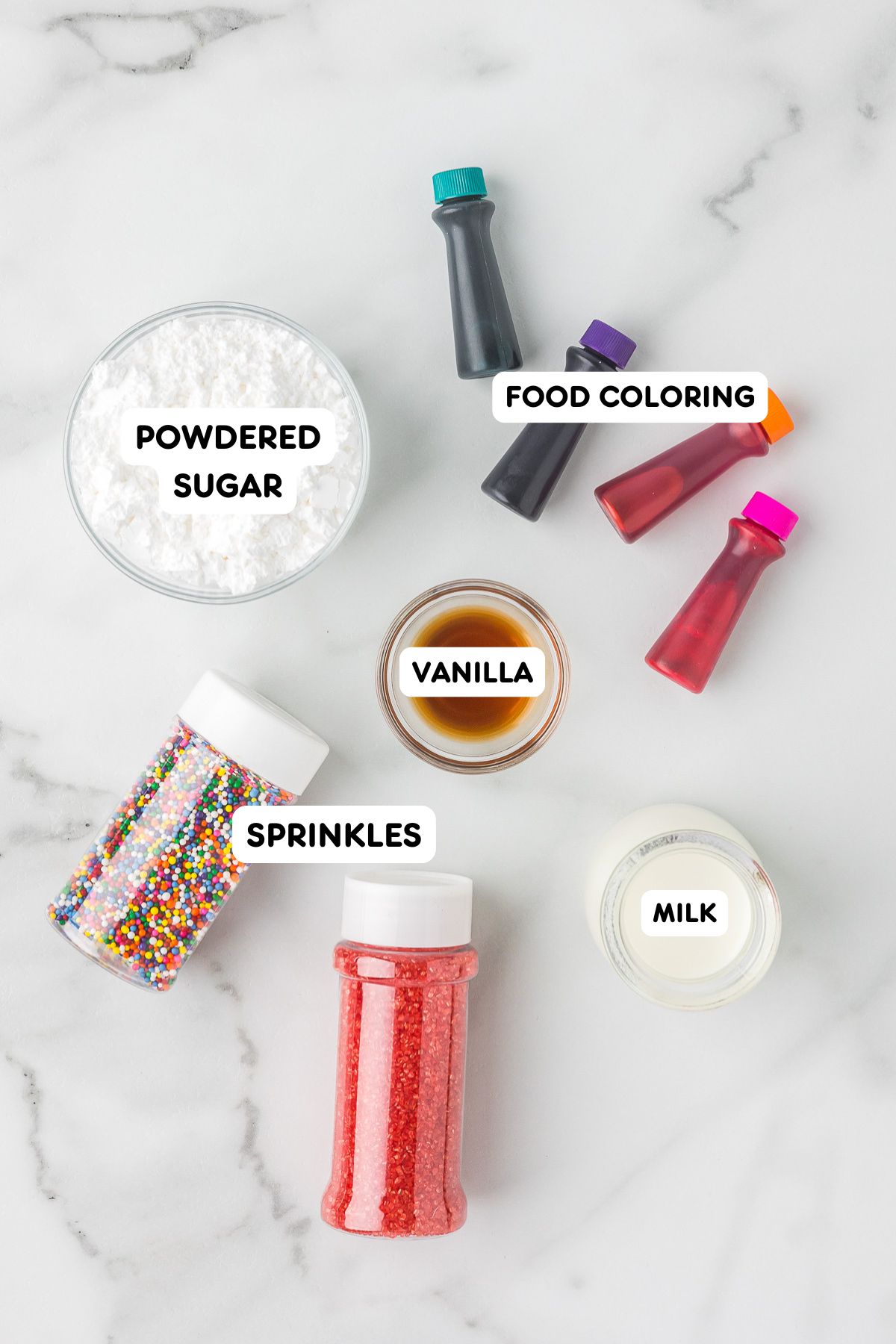 Powdered sugar icing ingredients with vanilla, milk, food coloring, and sprinkles for decorating cut out sugar cookies.