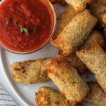 Air Fryer Cheese Sticks beside marinara sauce