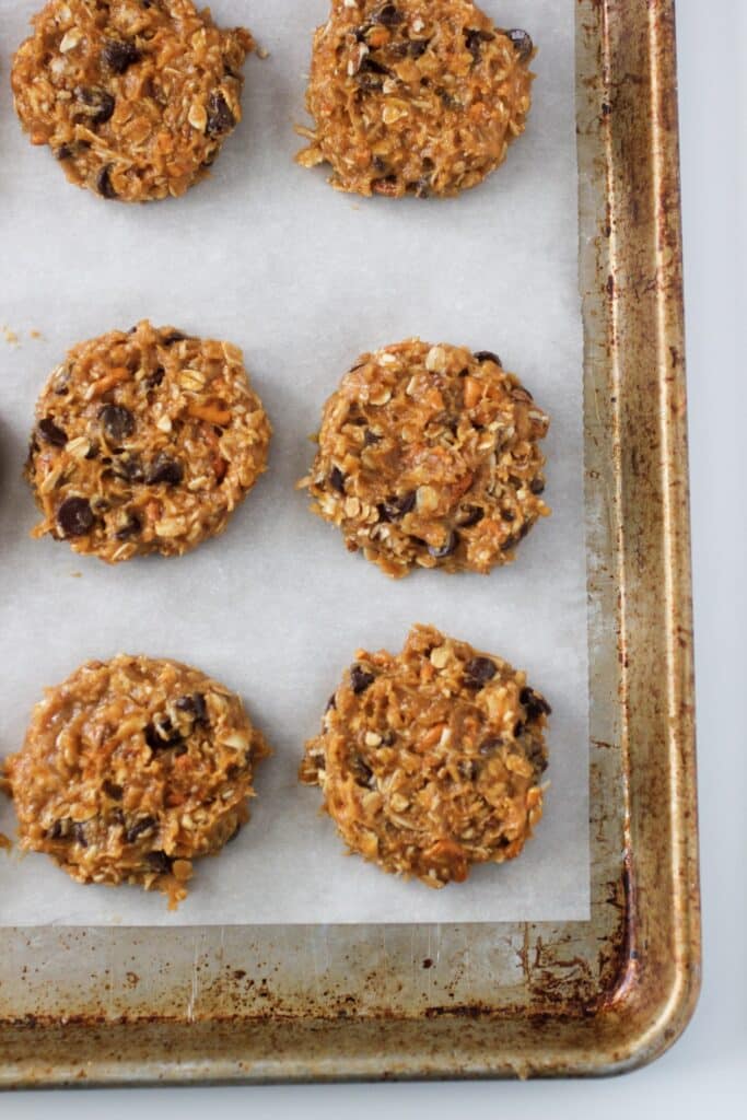 Peanut Butter Breakfast Cookies on a cookie sheet on parchment paper before baking.