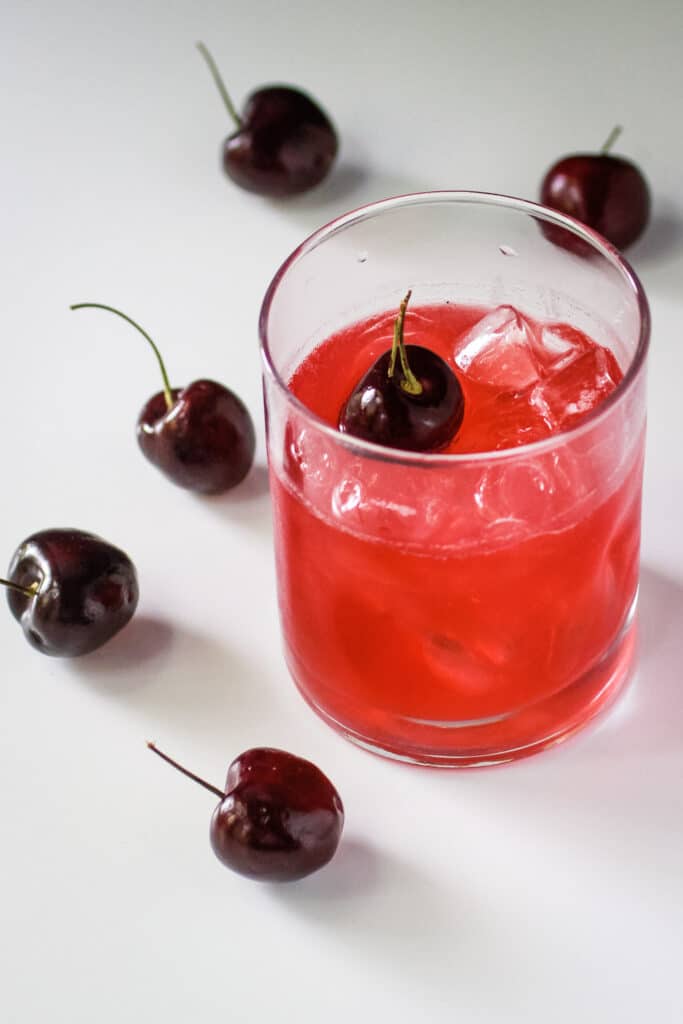 Cherry Simple Syrup in a glass with club soda.