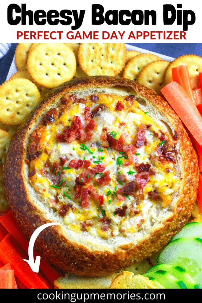 cheesy bacon dip in bread bowl served with crackers and vegetables