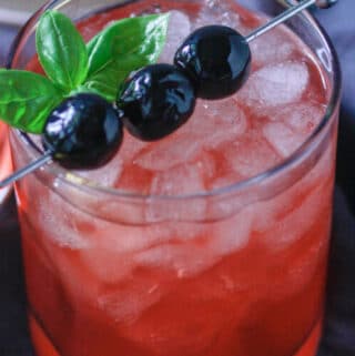 Cherry Whiskey Sour Drink with garnish on top