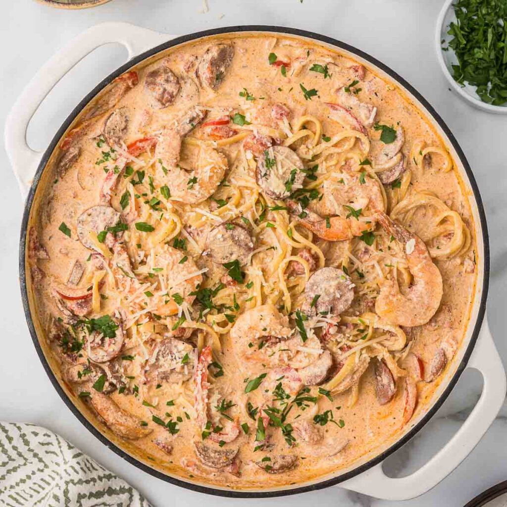 Cajun pasta with shrimp and sausage in a dutch oven.