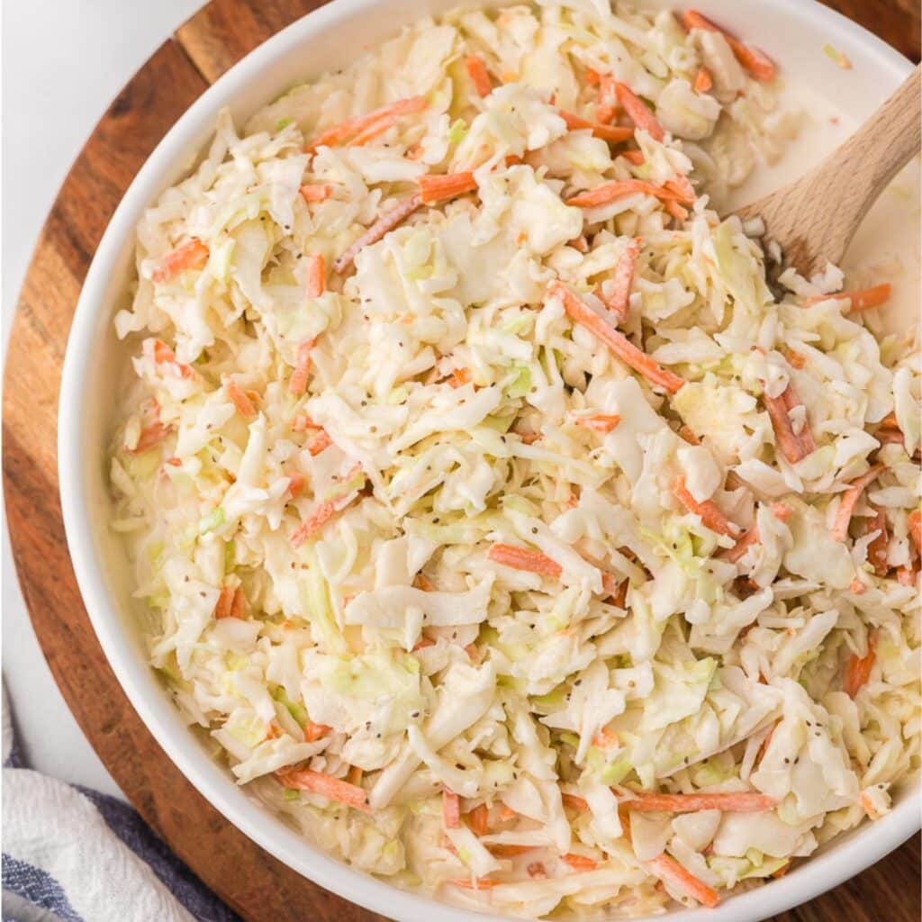 Creamy Sweet Slaw in a white bowl.