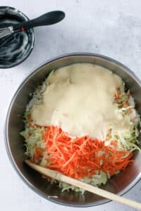 Ingredients for Coleslaw in a mixing bowl before tossing.
