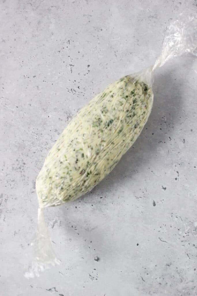 Herb butter wrapped in plastic wrap.