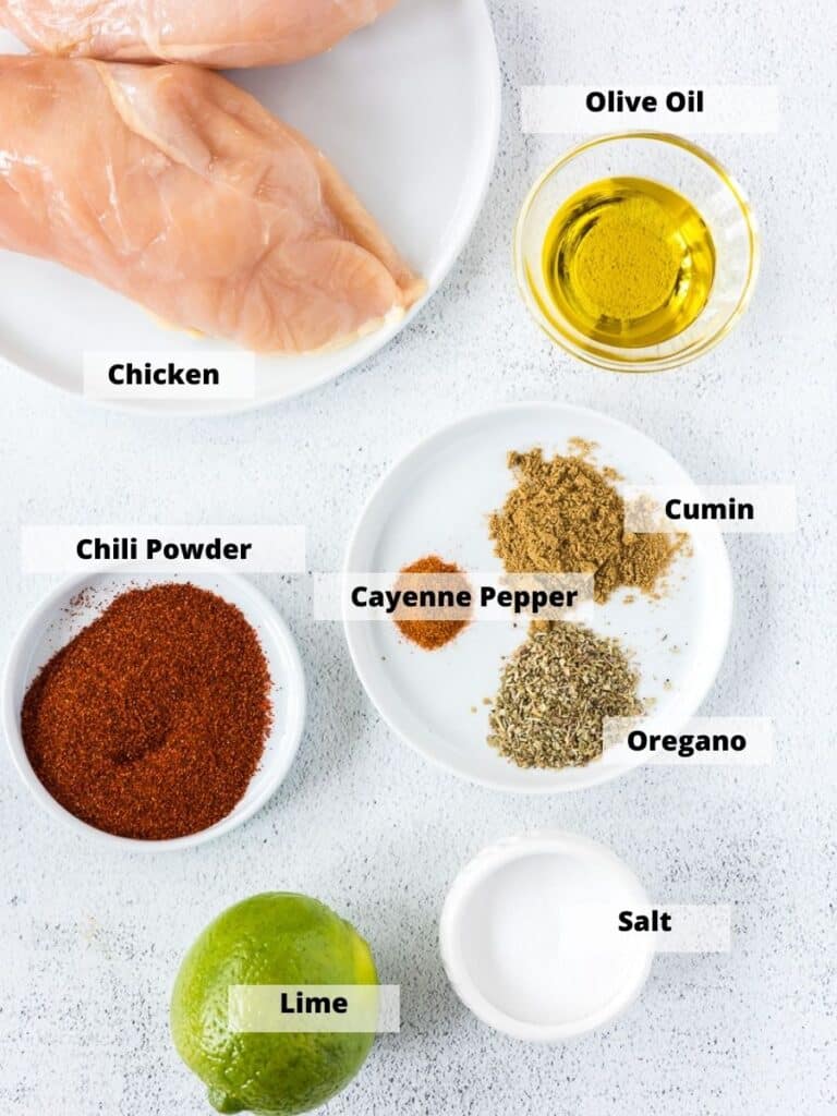 Ingredients to make Mexican Chicken Breast including chicken, spices, lime and olive oil.