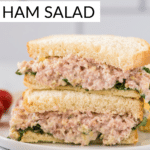 ham salad on white bread stacked one half on top of the other half.