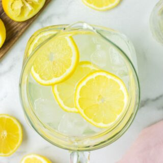 Fresh Squeezed Lemonade in a pitcher with lemon slices.