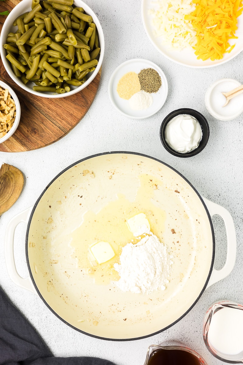 Dutch oven with butter and flour beginning to cook sauce for hamburger green bean casserole.