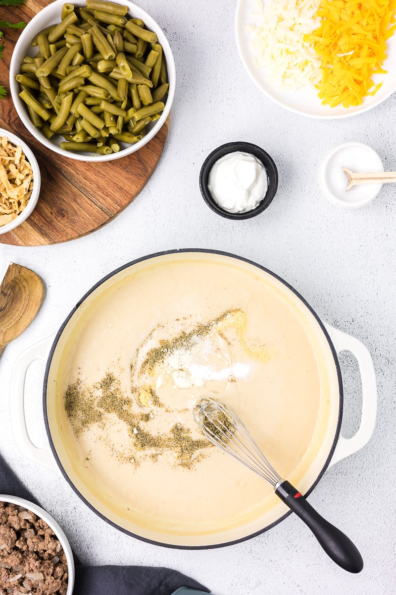 Hamburger green bean casserole sauce in a white pan.