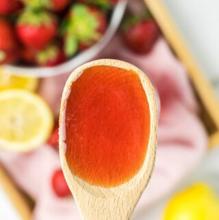 Strawberry Simple Syrup on a spoon.