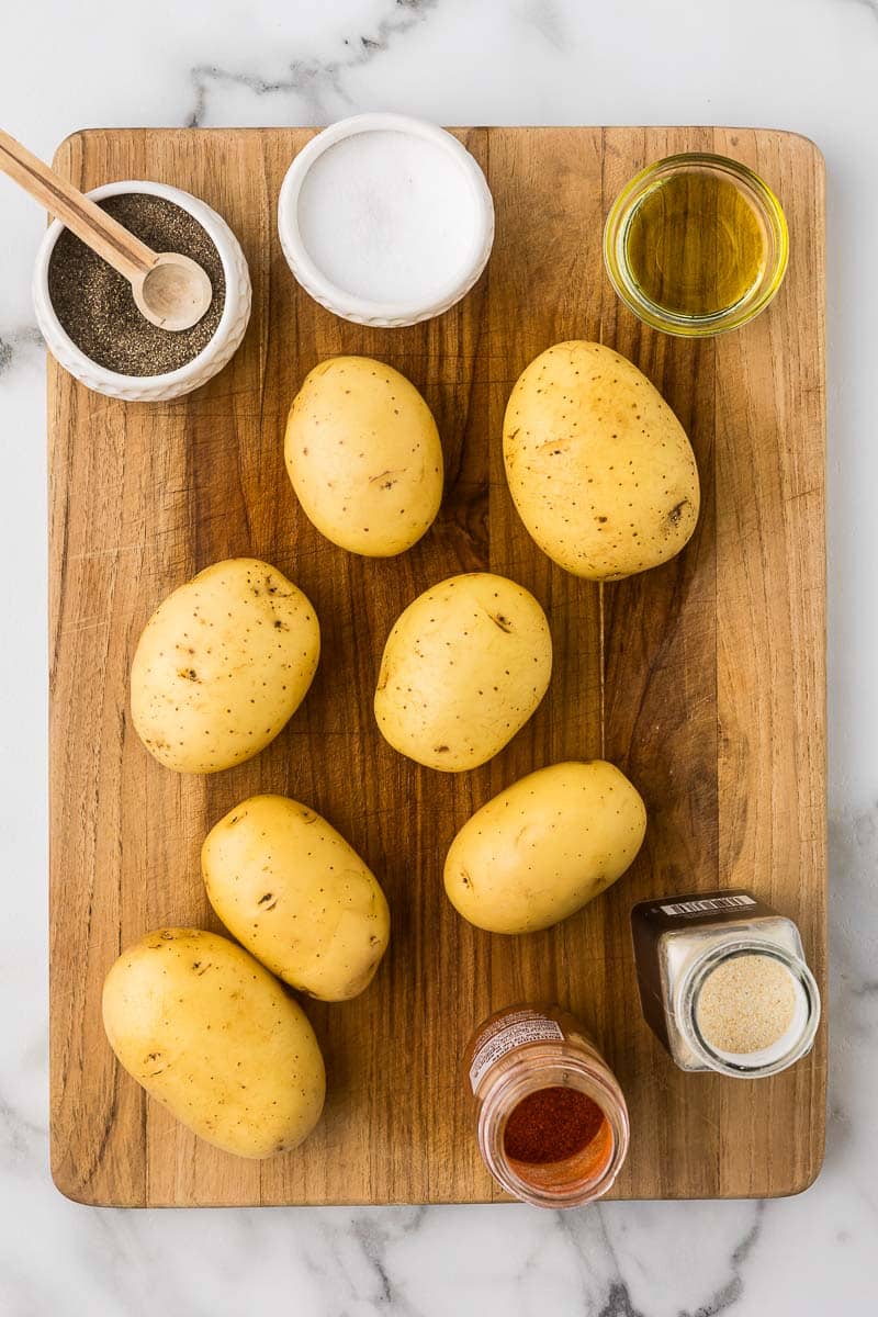 Yukon potatoes with spices on a cutting board to make fried potatoes breakfast in the air fryer.