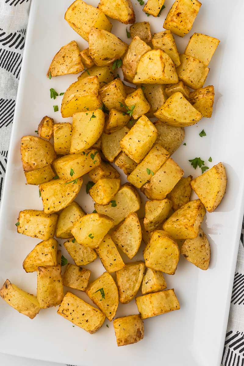 Homestyle breakfast potatoes on a white serving plate.