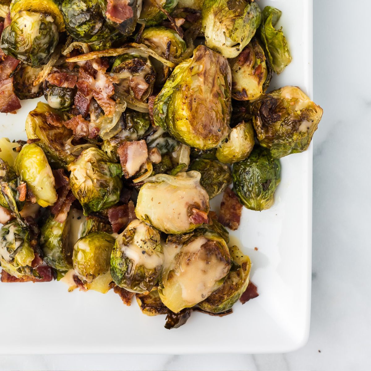 Brussels Sprouts with Bacon on a white platter.