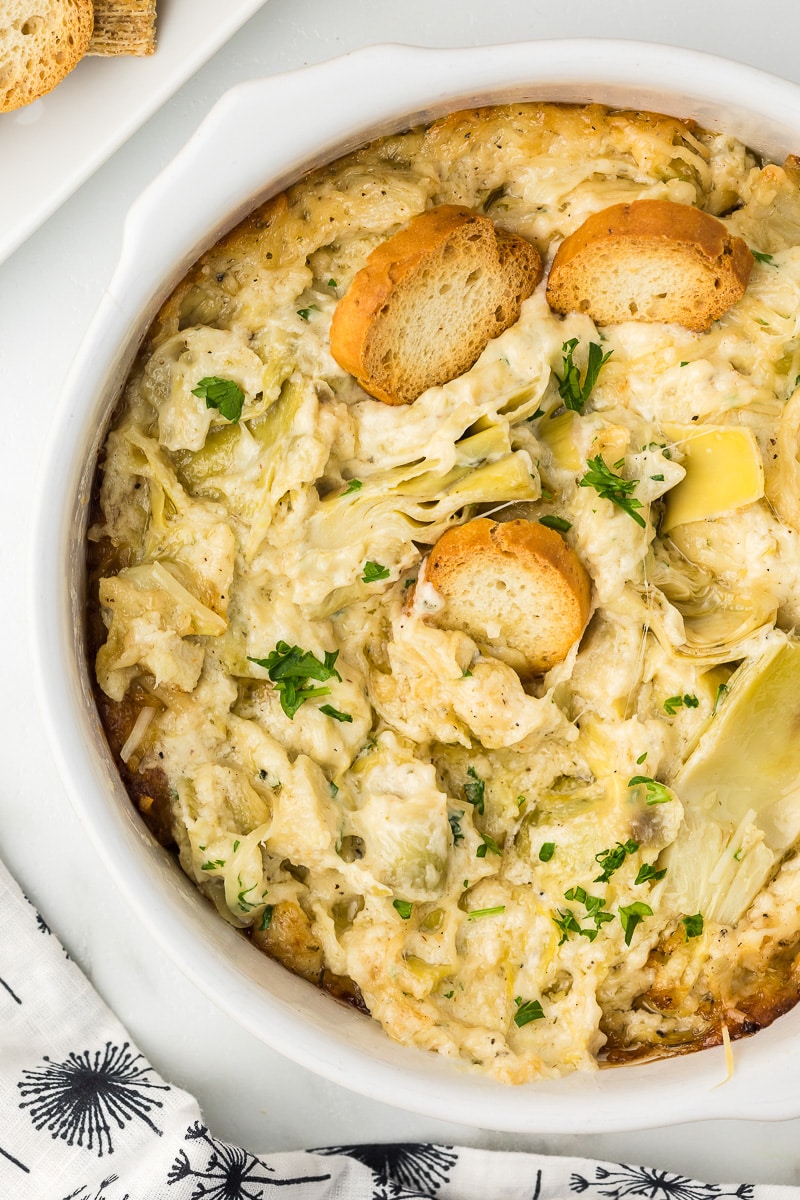 Hot Artichoke Dip in a white baking dish.