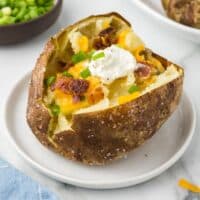 Air Fryer Loaded Baked Potato on a white plate.