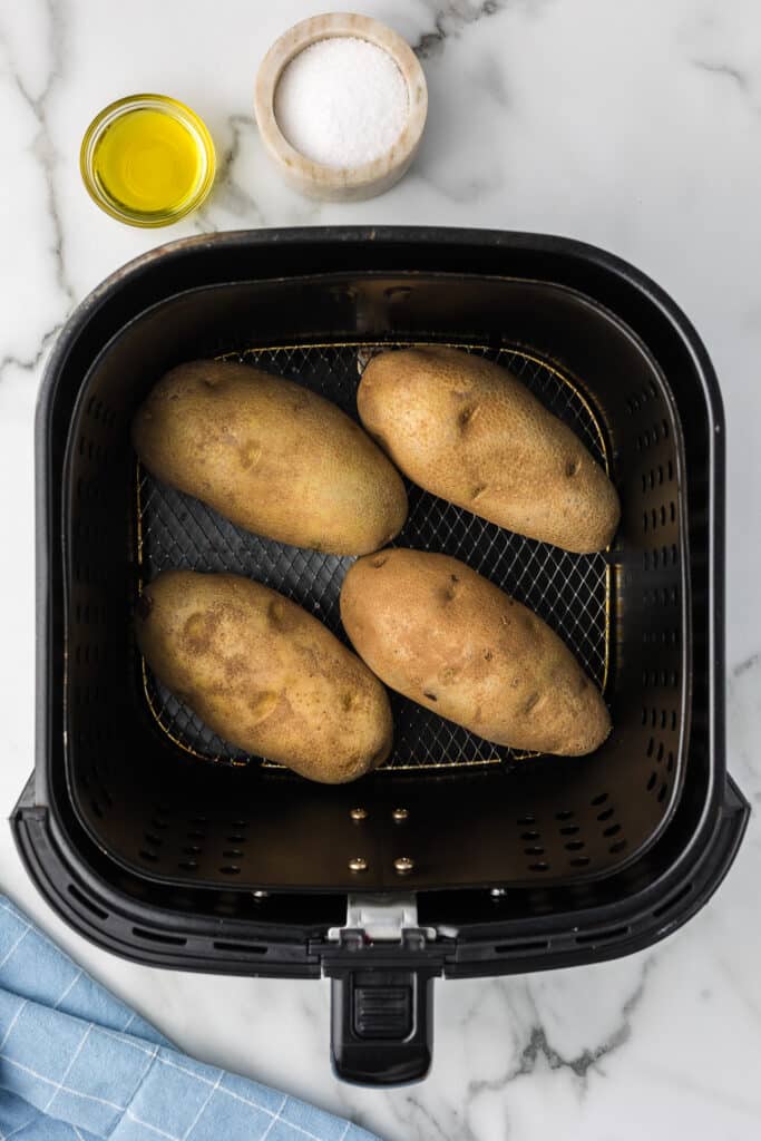 Potatoes in air fryer basket.