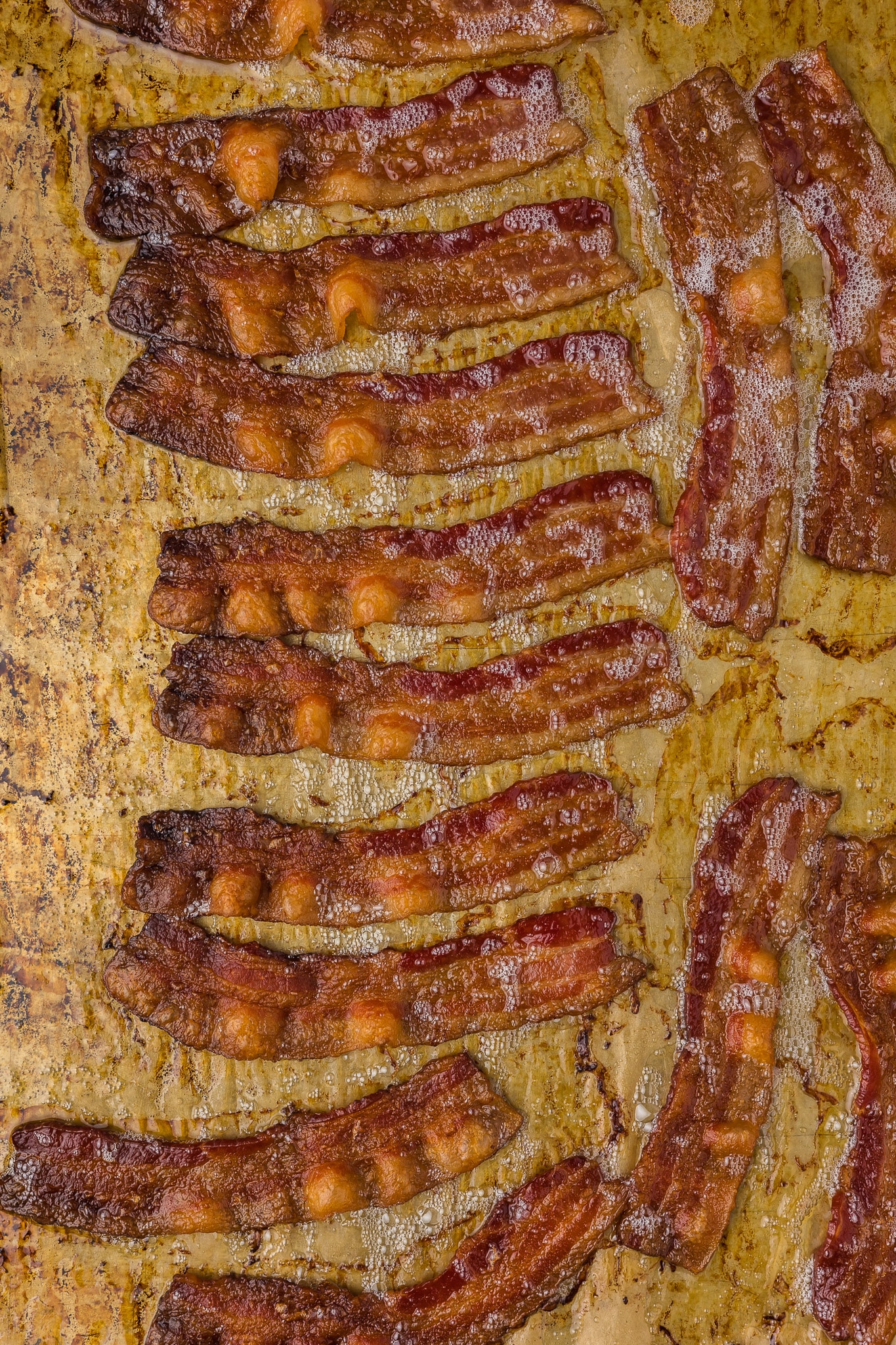 Cooked bacon on a cookie sheet.