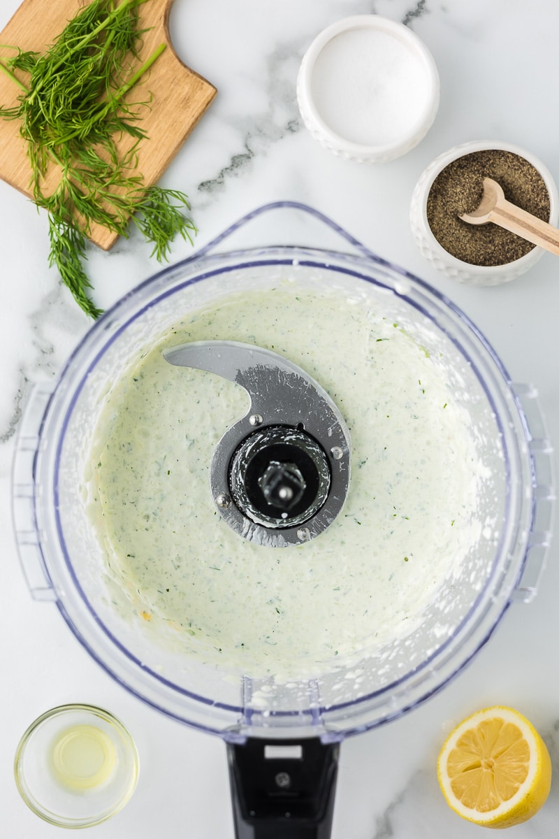 Tzatziki sauce in the bowl of a food processor.