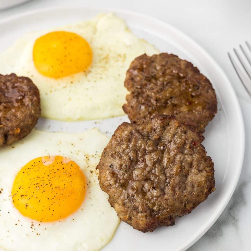 Air Fryer Breakfast Sausage Patties with over easy eggs.