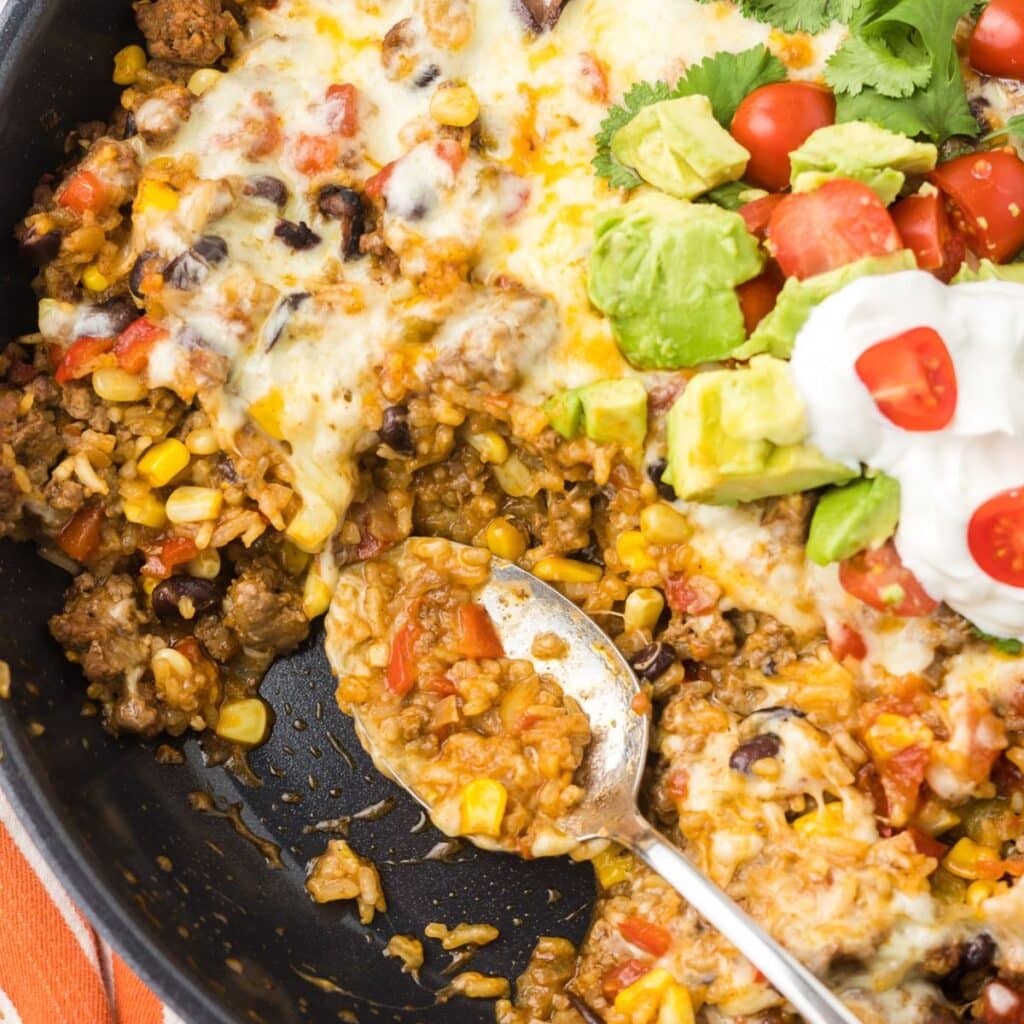 One Pot Cheesy Taco Skillet with a portion mission and a spoon.