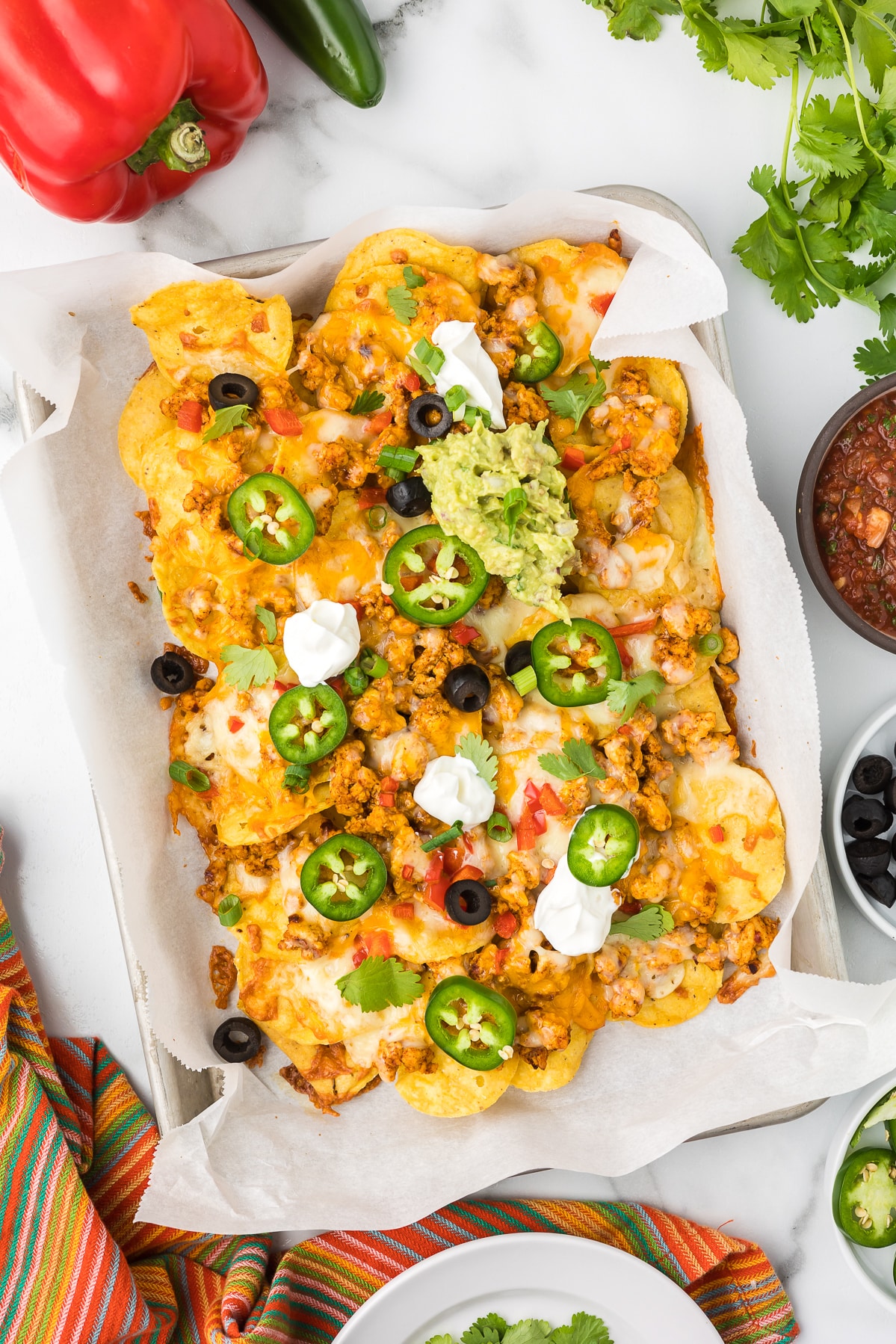 Sheet Pan Chicken Nachoes with toppings.