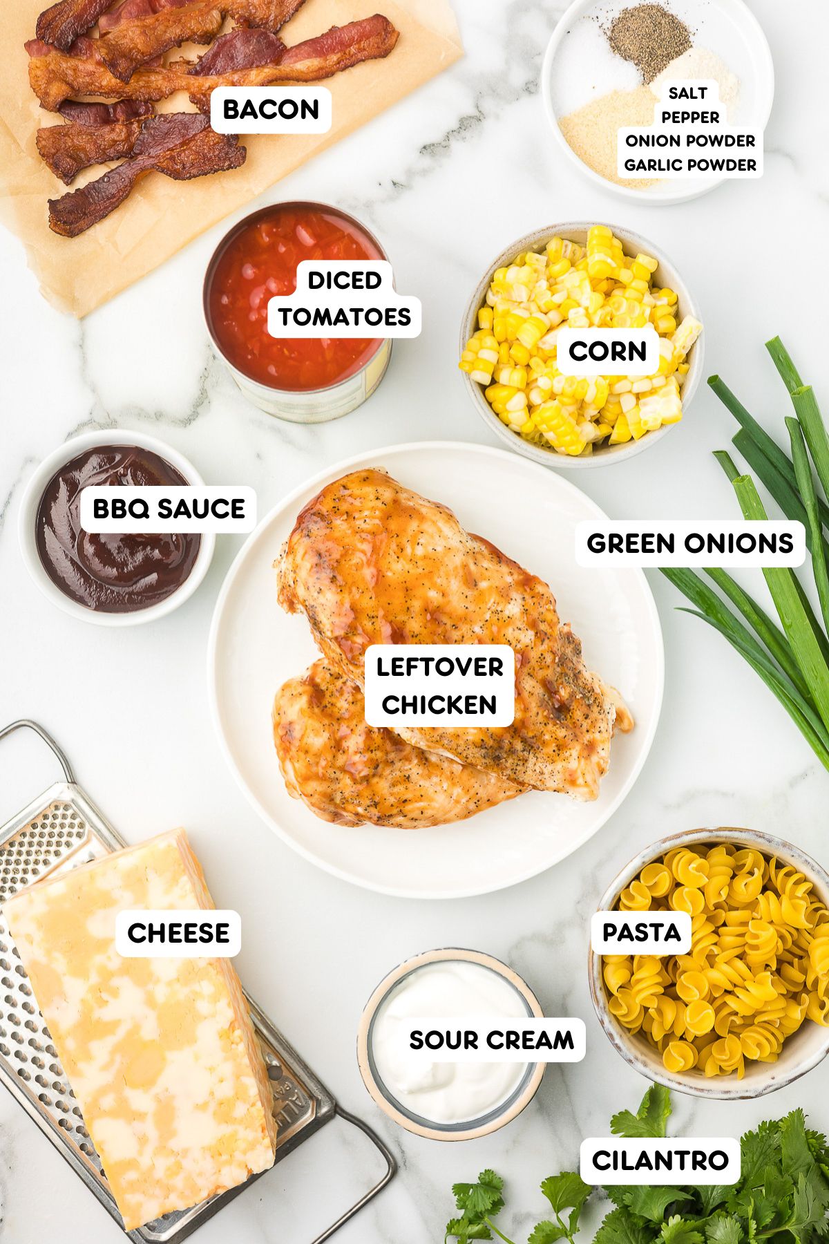 Ingredients to make chicken casserole with leftover chicken, corn, tomatoes, sour cream, pasta, cilantro, bacon and spices.