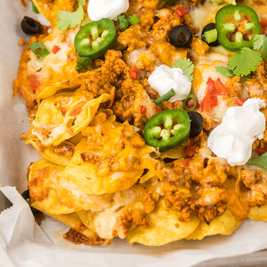 Sheet Pan Chicken Nachos with toppings.