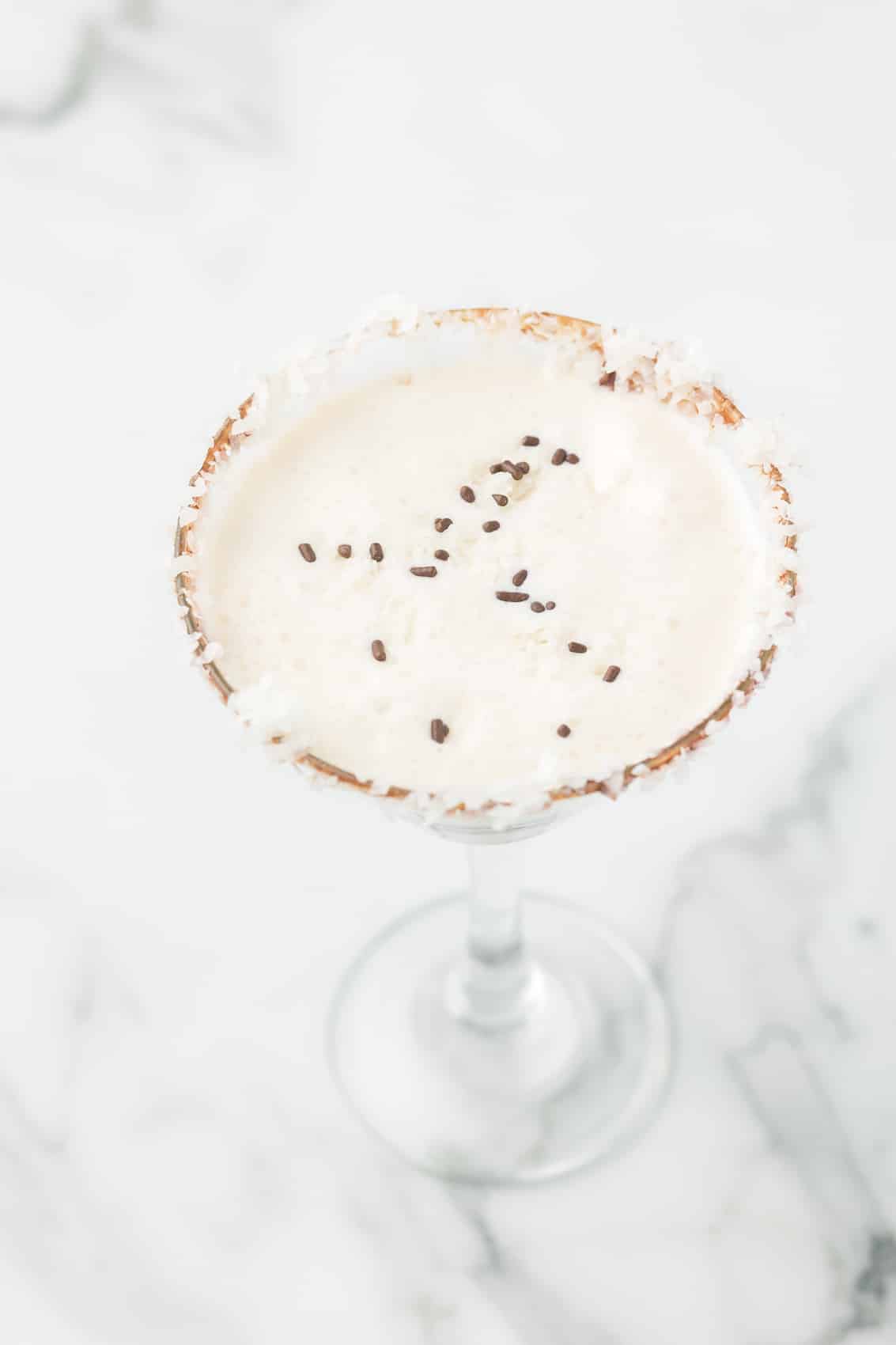 Almond Joy Martini with a coconut rim and chocolate sprinkles.
