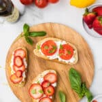 Toast with a layer of cottage cheese, and strawberries and tomatoes with basil.