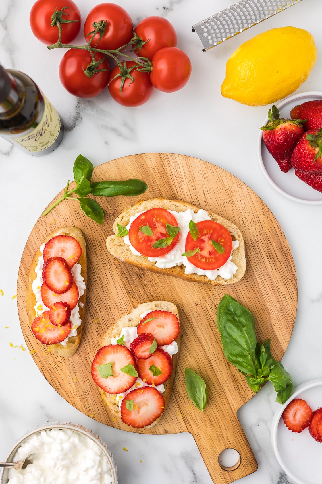 Toast with a layer of cottage cheese, and strawberries and tomatoes with basil.