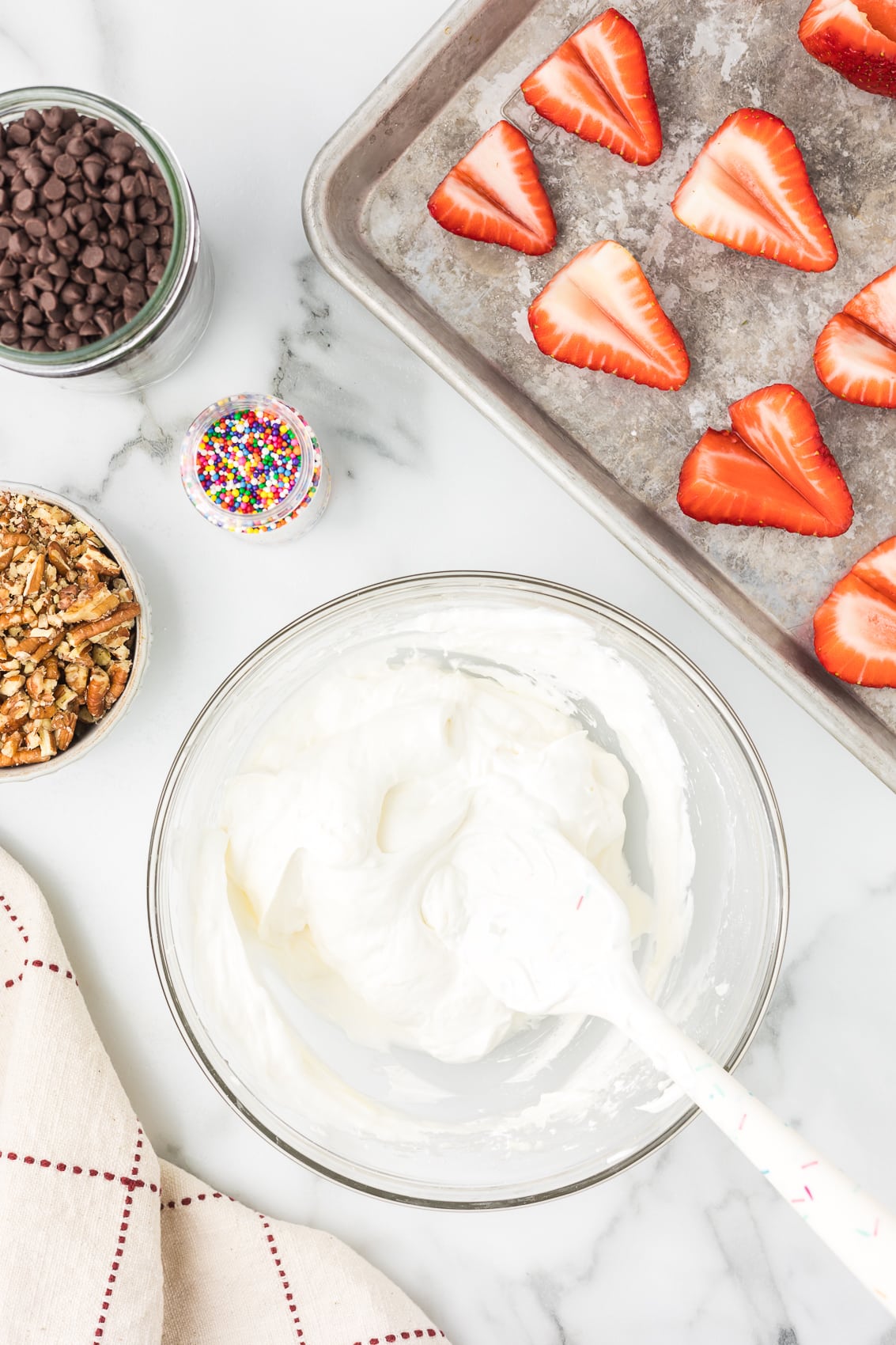 Whipped topping being folded into cream cheese mixture.